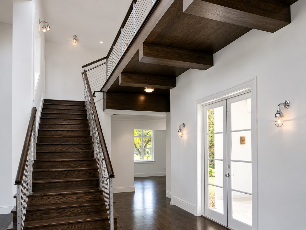 Stair hall with beamed ceiling and wood staircase